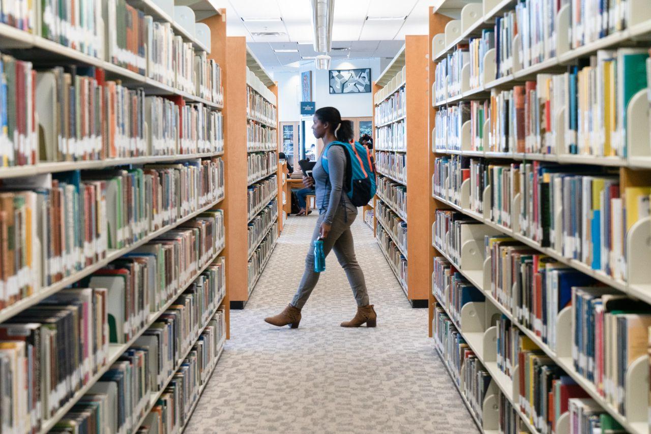 Student walks through Library